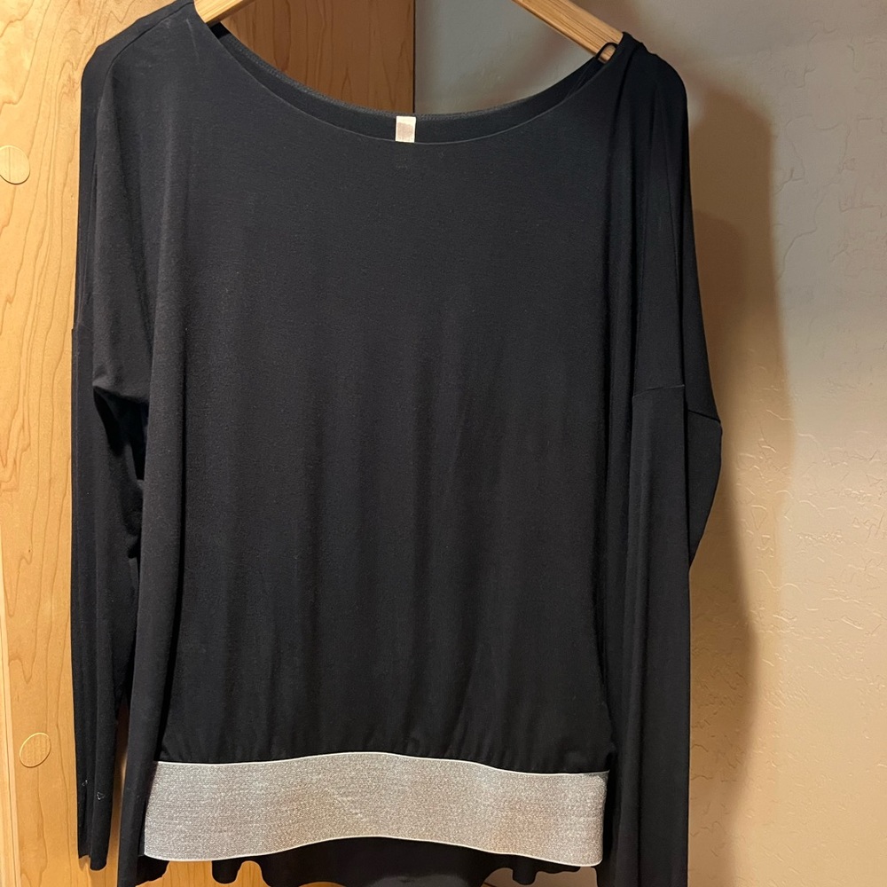 Bailey 44 Party top,black with a stretch silver waste band, fitted long sleeves.